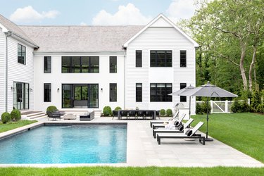 Traditional backyard pool design with clean lines and classic patio furniture