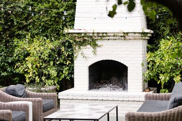 Fireplace on patio with patio chairs and coffee table