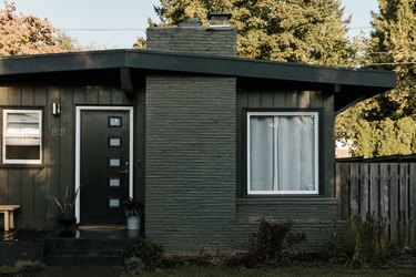 The front entrance of a midcentury ranch outside of Portland, painted black