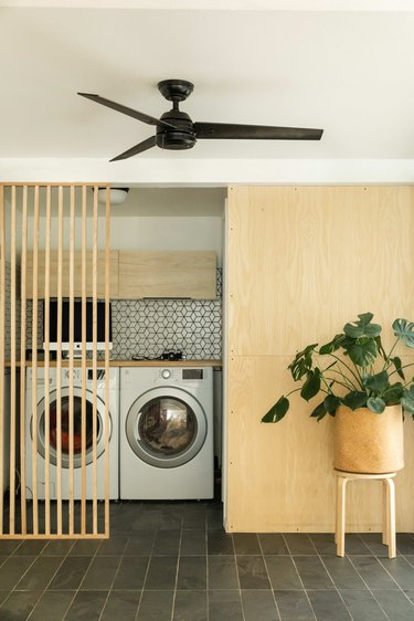 The laundry area includes birch plywood walls added to bring some warmth to the decor.