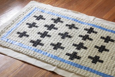 Painting crosses onto a jute rug