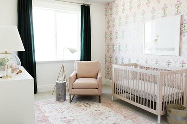 baby nursery design with rocking chair and floral accent wall