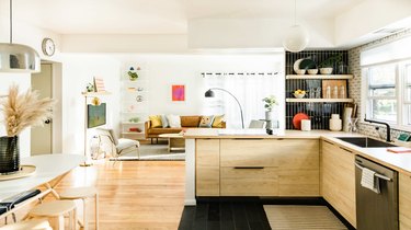 Kitchen that opens up into living room with bright natural light