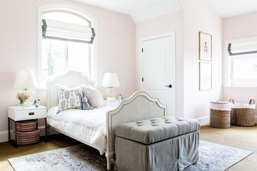 pink kids bedroom idea with Roman shades at windows and tufted bed bench