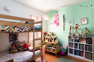 Kids' bedroom with bunk beds and green painted wall