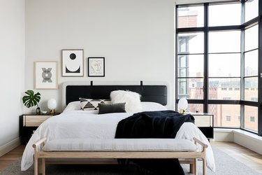 A white bedroom with black accents