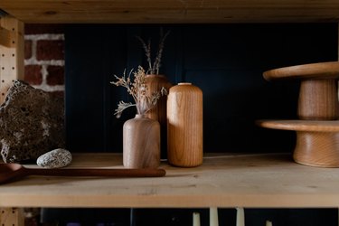 shelf with wooden vases and other wooden pieces