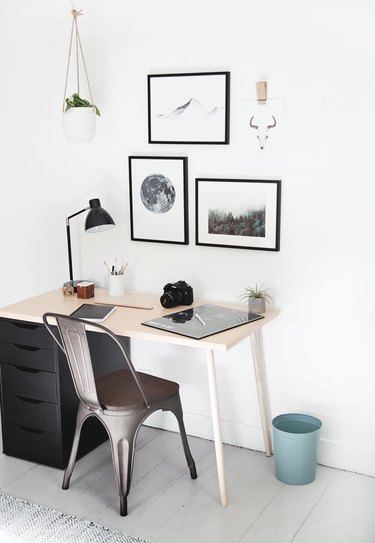 Kids' bedroom desk with minimal decor and black and white wall art
