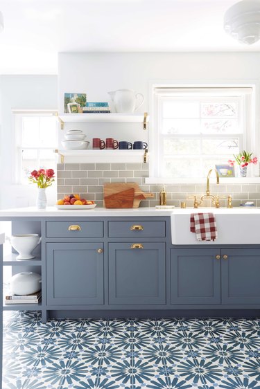 light blue kitchen cabinets with patterned tile floor