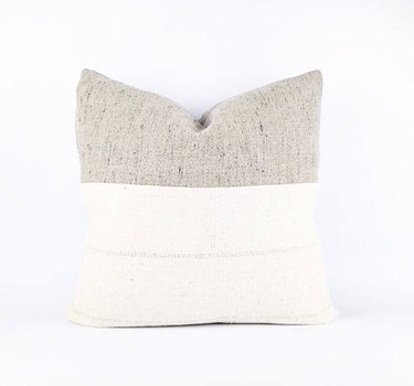 White square throw pillow with thick greige accent stripe