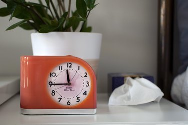 Small alarm clock on side table