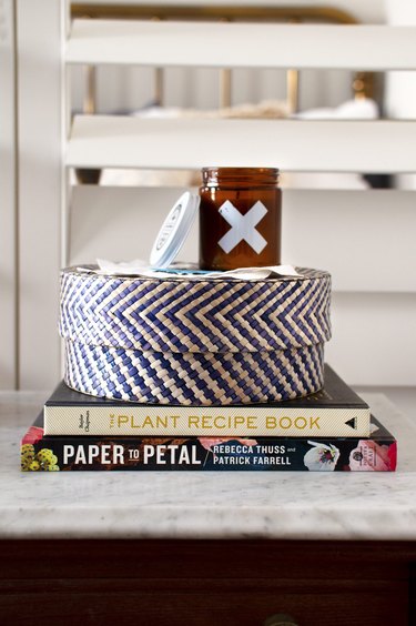 Storage basket set upon books