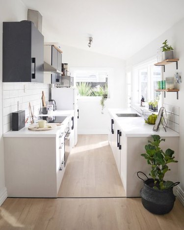 white galley kitchen with subway tile clad walls