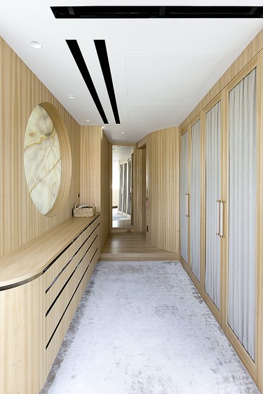 narrow hallway with wood built ins
