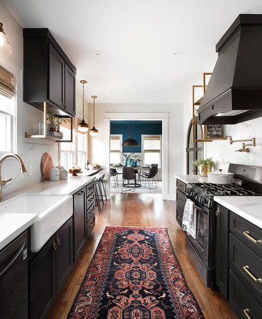 galley shaped kitchen in black with kilim runner