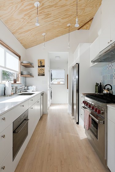 white galley kitchen with angled ceiling