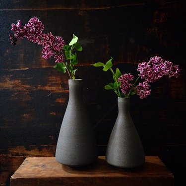 two black stoneware vases with flowers