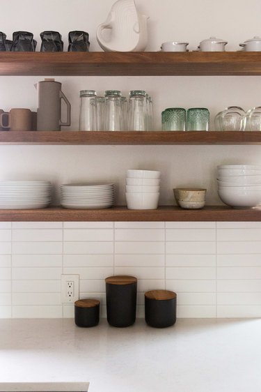 Open shelves over quartz countertop.