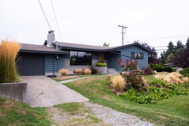 Exterior of home painted blue with dark painted garage door