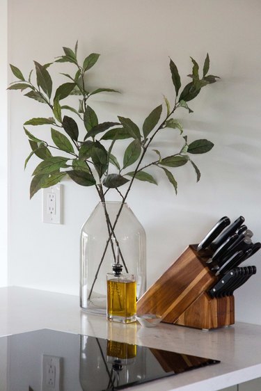 GE cooktop with set of knives and plant in glass vase