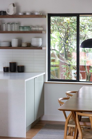 Kitchen windows bringing in natural light to minimal kitchen