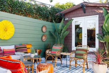 Colorful small patio ideas with green, yellow, orange, and red decor accents