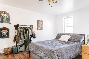 bedroom idea with wardrobe rack and jackets hung on wall