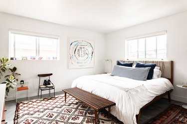 bedroom idea with bed bench at foot of bed and area rug