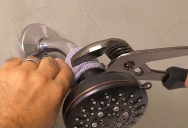 Pliers removing shower head