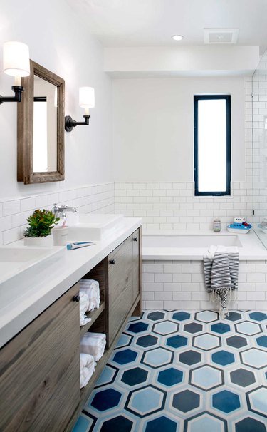 kids bathroom idea with colorful hex tiles, white subway, walnut vanity