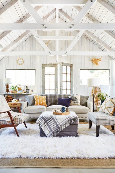 living room with whitewashed a-frame interior and plaid accent decoro