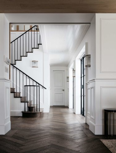 hallway with herringbone pattern wood flooring