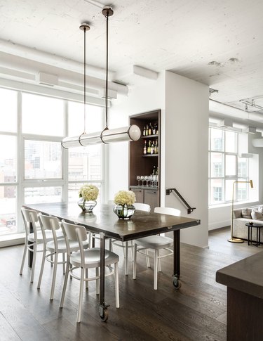 bright dining room with dark wood flooring