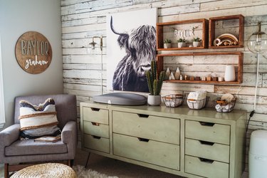 nursery idea with distressed wood walls and green dresser