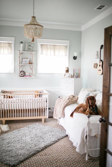 Blue nursery idea with light woods and layered rugs