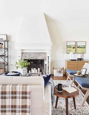 traditional living room with beige couch with plaid throw draped over the back