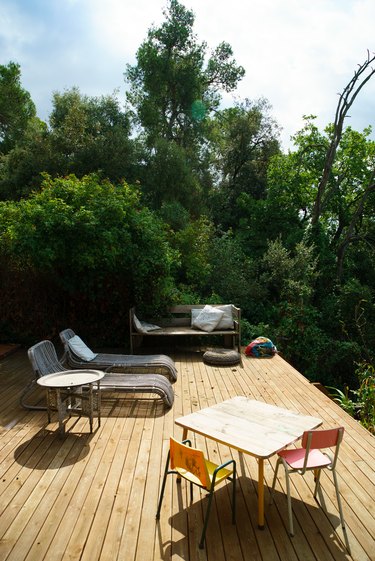 Patio with chairs surrounded by trees