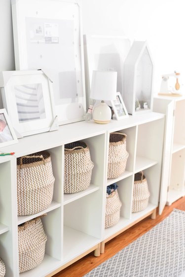 Baskets in cubbies playroom storage idea with white furniture and decor