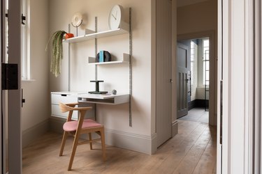 blush modern home office installed in a corner with wall unit that includes desk and chair