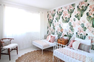 green kids bedroom idea with cactus wallpaper, white iron beds