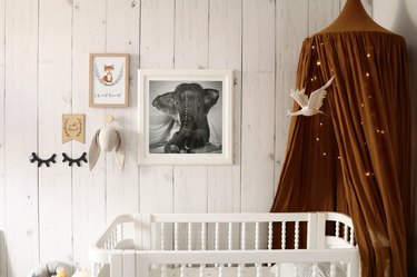 Nursery idea for 2020 with ceiling canopy around white crib