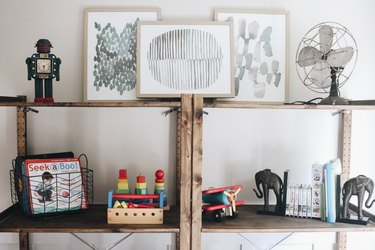 Organized bookshelf playroom storage idea with rustic wooden bookcase