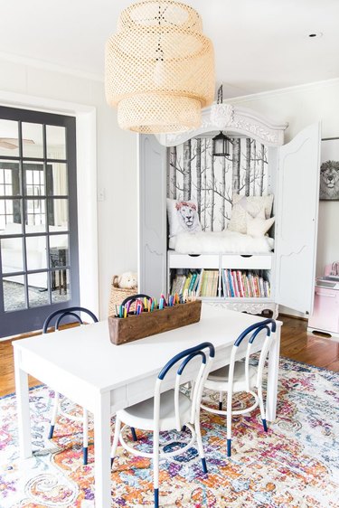 kids playroom idea with reading nook inside cabinet with table and chairs for arts and crafts