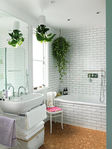 bohemian white bathroom with cork flooring and hanging plants