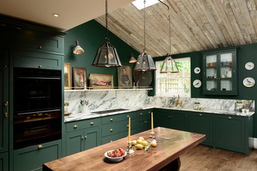 green kitchen with marble backsplash