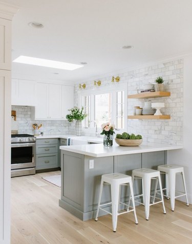 gray and white kitchen with marble tile backsplash