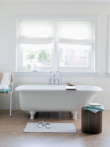white bathroom with cork flooring and Roman shades