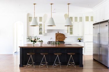 kitchen space with stools and hanging light fixtures
