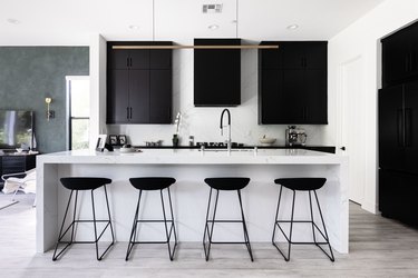 kitchen island and bar stools with grey hardwood flooring