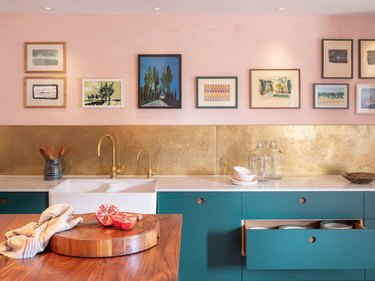 Should Wall Color Match Kitchen Cabinets in eclectic kitchen with pink walls, gold backsplash and teal cabinetry